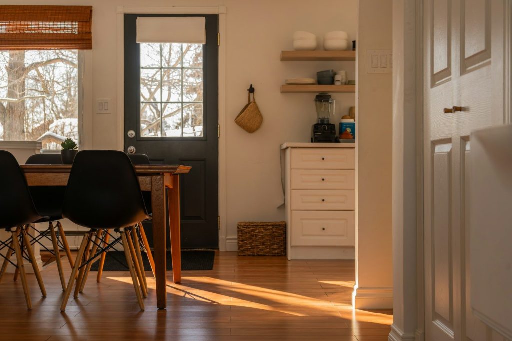 Sunlight streams into a cozy dining area and kitchen.