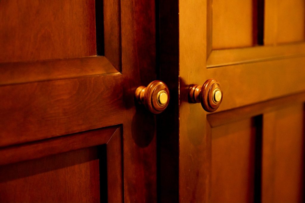 brown wooden door with brass door knob
