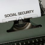 a close up of a typewriter with a paper that says social security