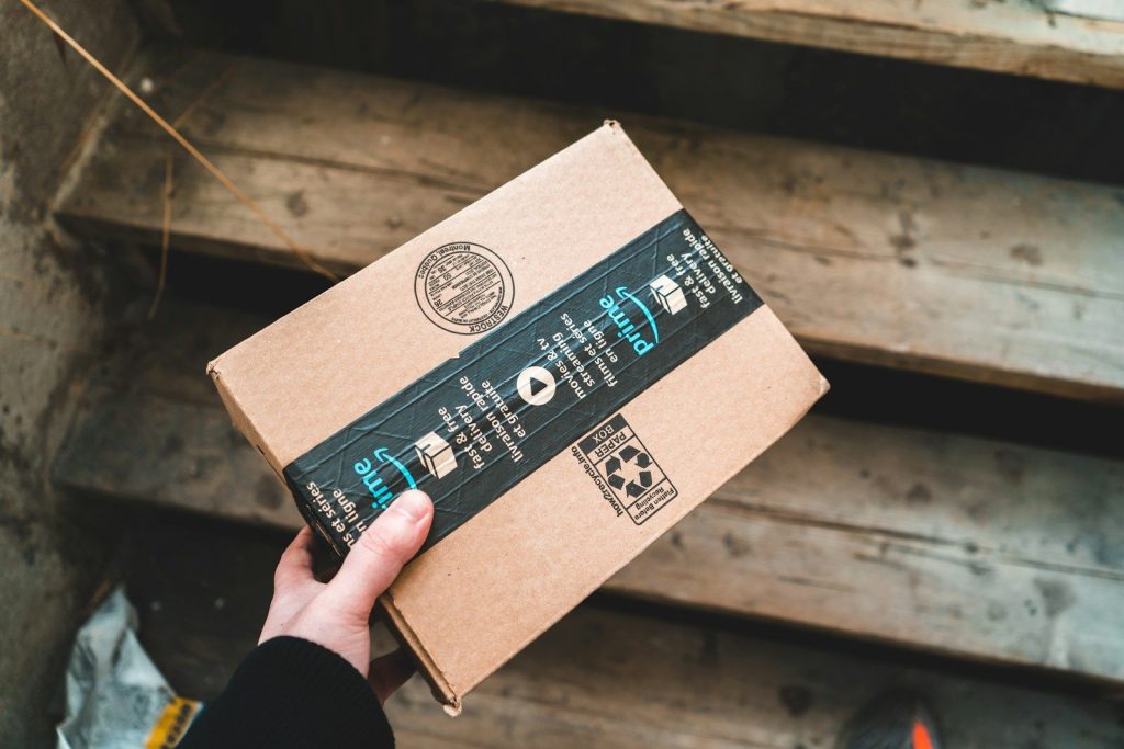 a person holding a cardboard box in their hand
