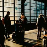 a group of people standing next to each other with luggage