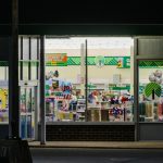a store front at night with the lights on