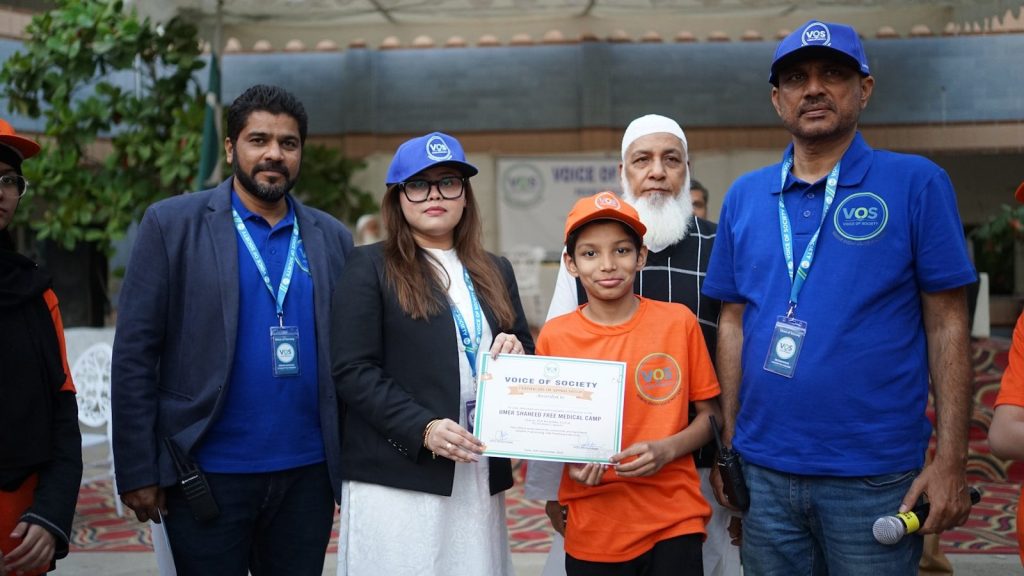 Five people at an event, a girl receiving a certificate.