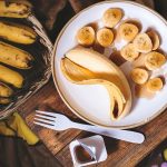 sliced ripe banana on round white ceramic plate