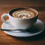 white ceramic teacup with coffee latte art