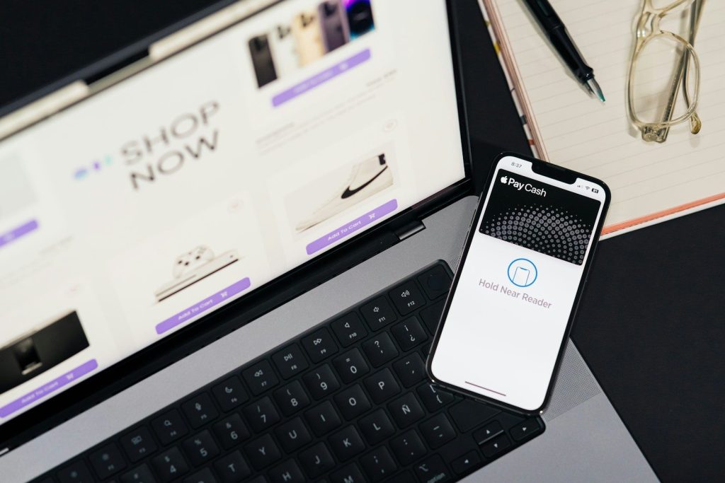 A cell phone sitting on top of a laptop computer