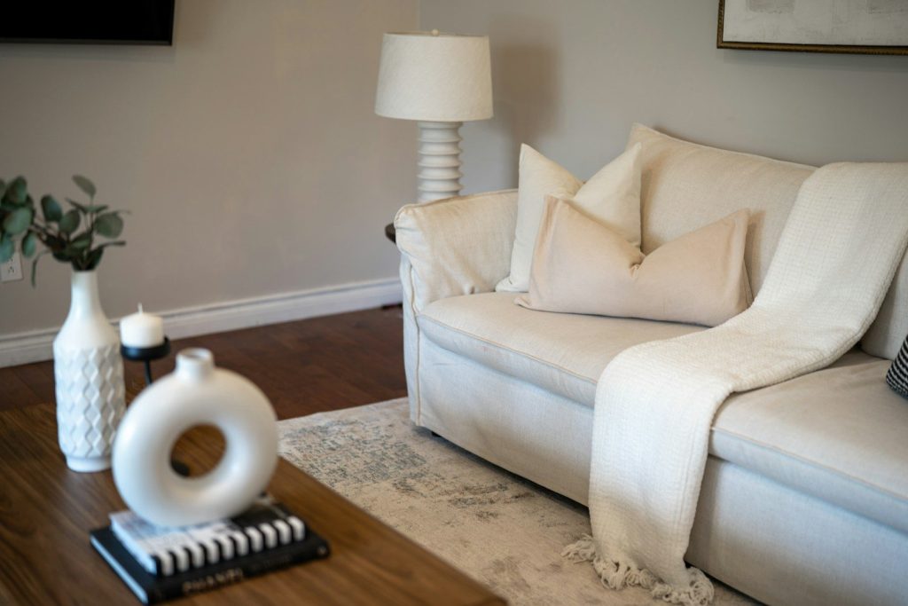 A cozy living room with a white sofa and decor.
