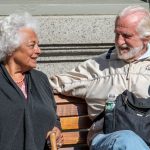 a man and a woman sitting on a bench