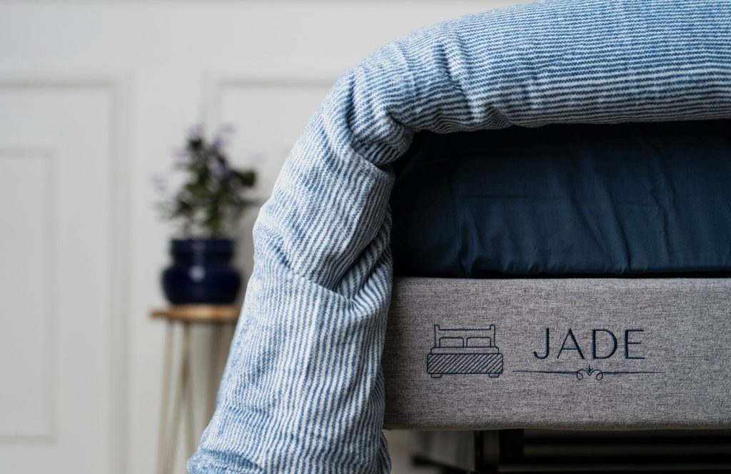 a close up of a bed with a name on it