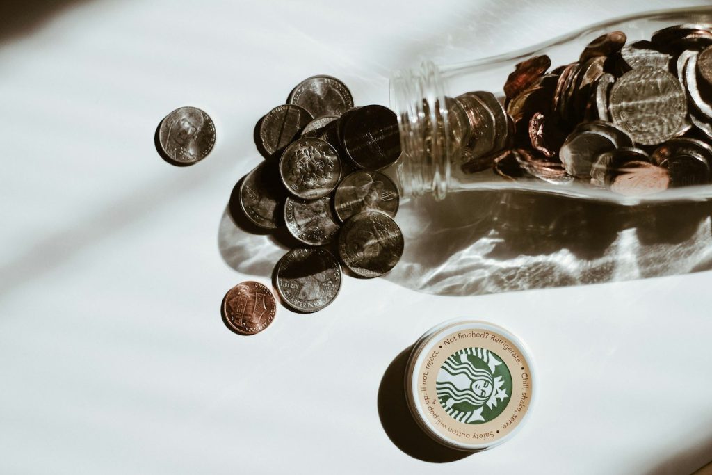 clear glass bottle with silver round coins