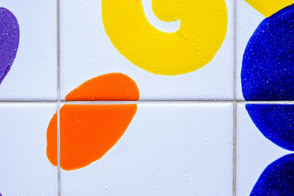 a close up of a tiled wall with different colors