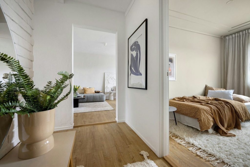 A bedroom with a bed and a potted plant