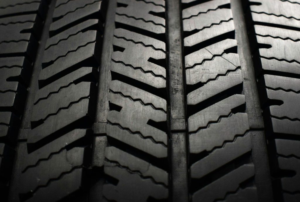A close up of a tire on a black background