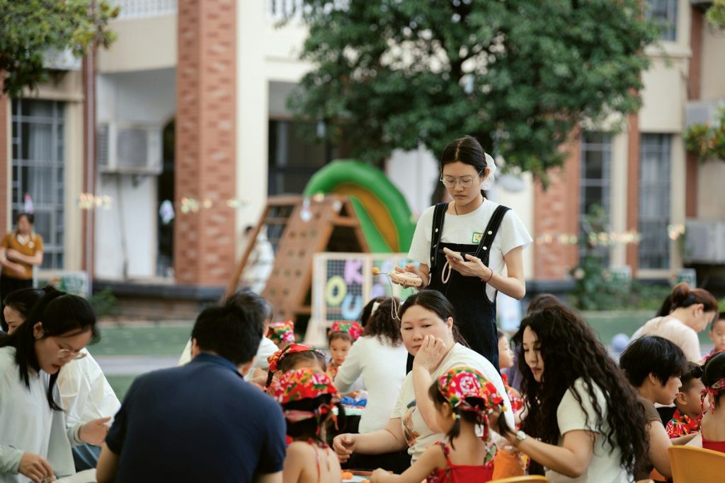 Adults and children enjoying an outdoor gathering.