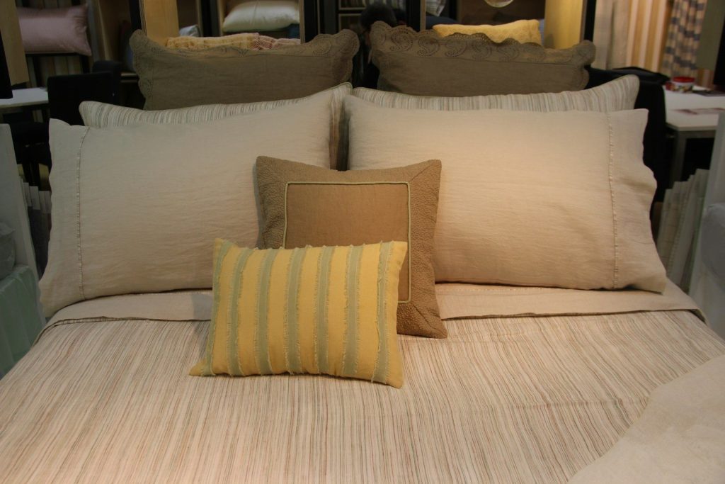 A well-made bed with fluffy pillows.