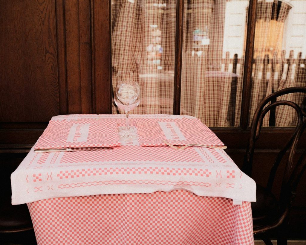 a table with a glass of wine on it