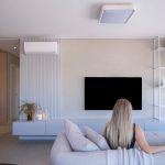 Woman relaxing on sofa in modern living room
