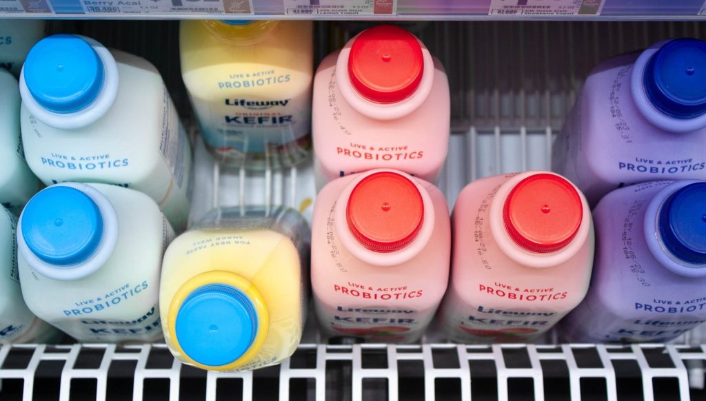 A refrigerator filled with lots of different colored bottles