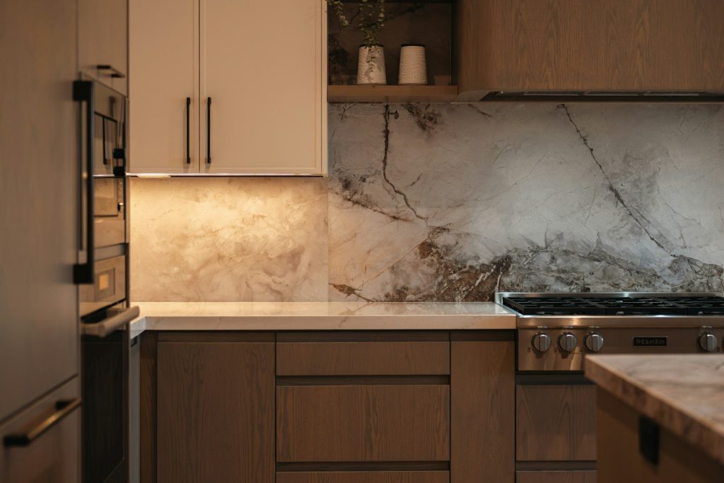 Modern kitchen with marble backsplash and stainless steel appliances