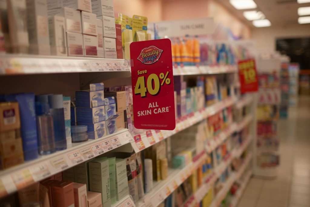 Skincare products on shelves with a 40% off sale sign.