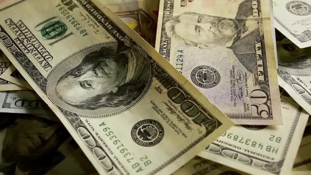 a pile of twenty dollar bills sitting on top of each other