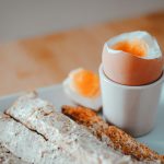 bread with egg on white ceramic plate
