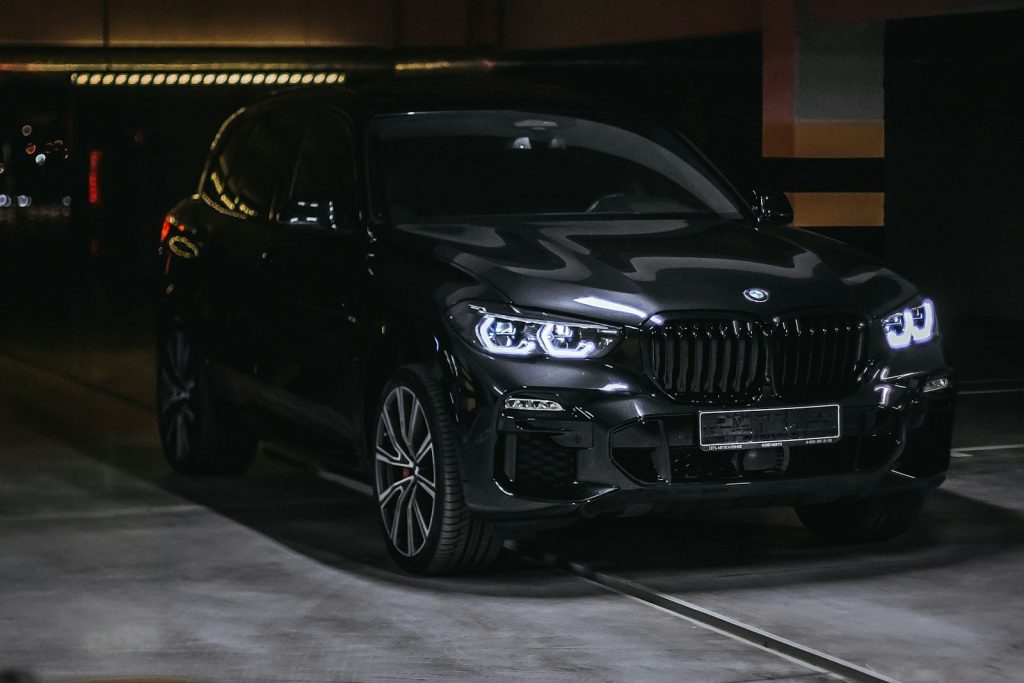a black car parked in a parking garage