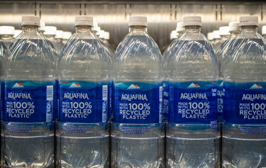 Bottles of aquafina water made with recycled plastic.
