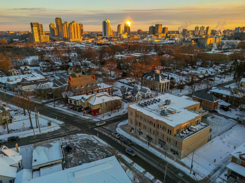 Snow covered city skyline at sunrise with warm light