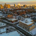 Snow covered city skyline at sunrise with warm light