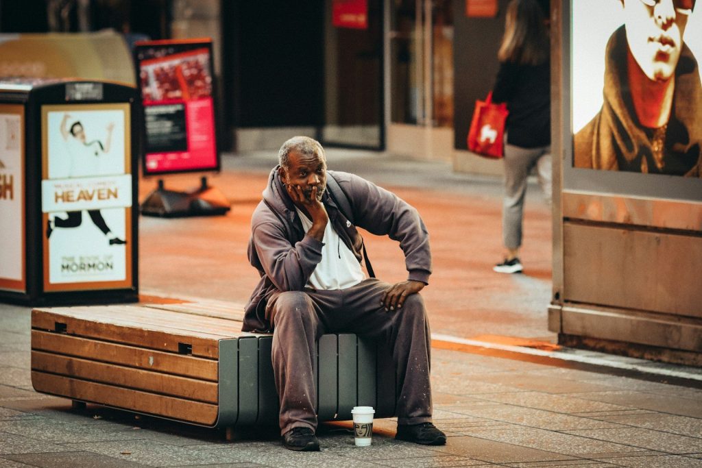 a person sitting on a bench talking on a cell phone