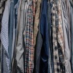 Assorted patterned shirts neatly arranged on a clothes rack.