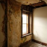 Explore an abandoned room with cracked walls and a weathered window exuding mystery.