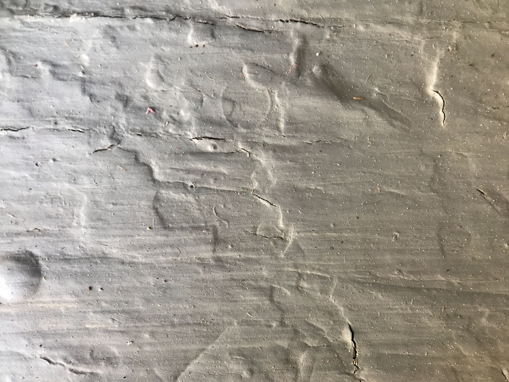 Detailed close up of a rough textured concrete wall surface, perfect for backgrounds.