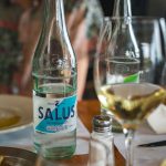 Close up of Salus water and wine glasses on a restaurant table in Uruguay.