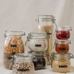 Stylish glass jars for zero waste kitchen storage, featuring grains and dried goods.