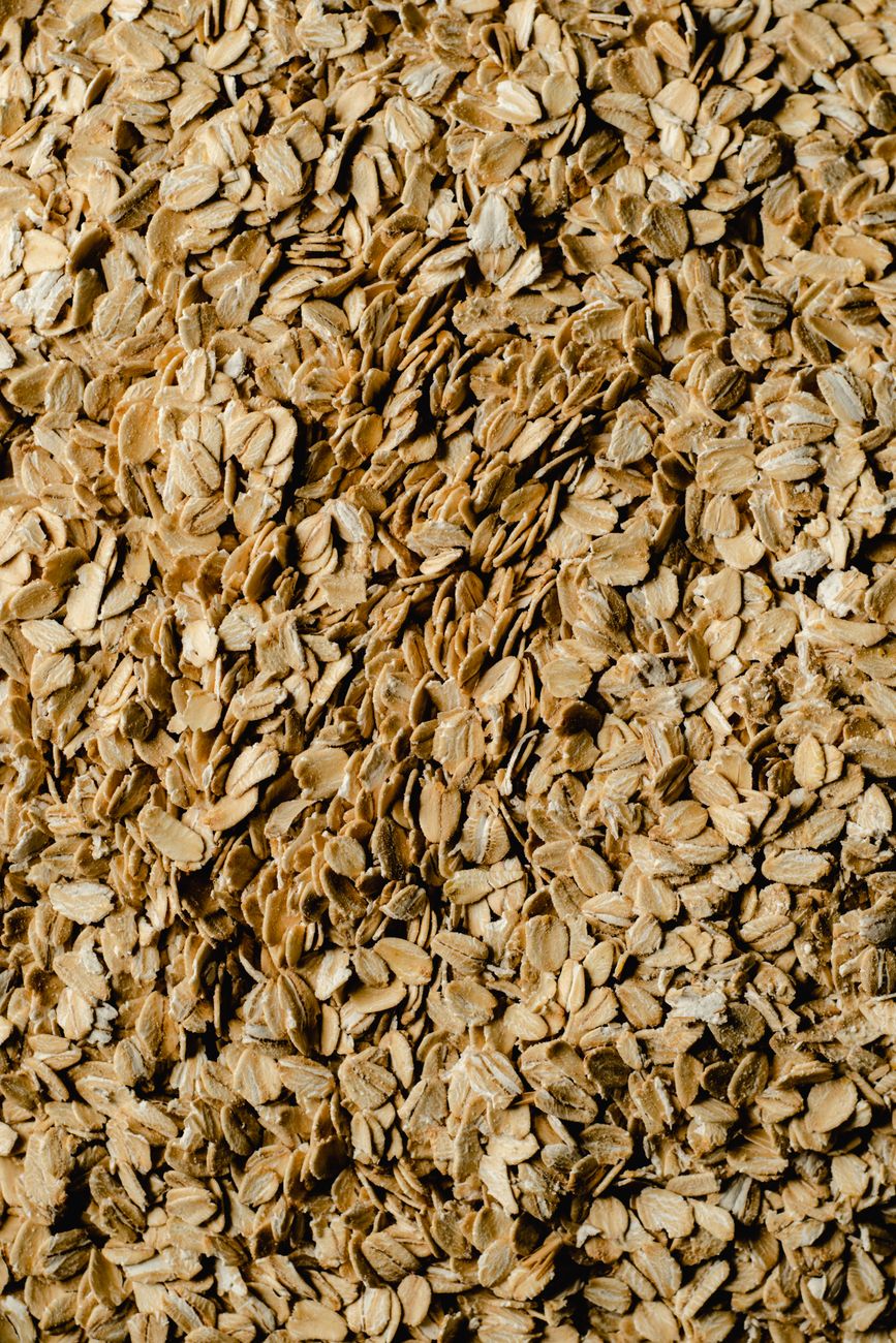 A detailed close up view of textured rolled oats, ideal for food and health themes.