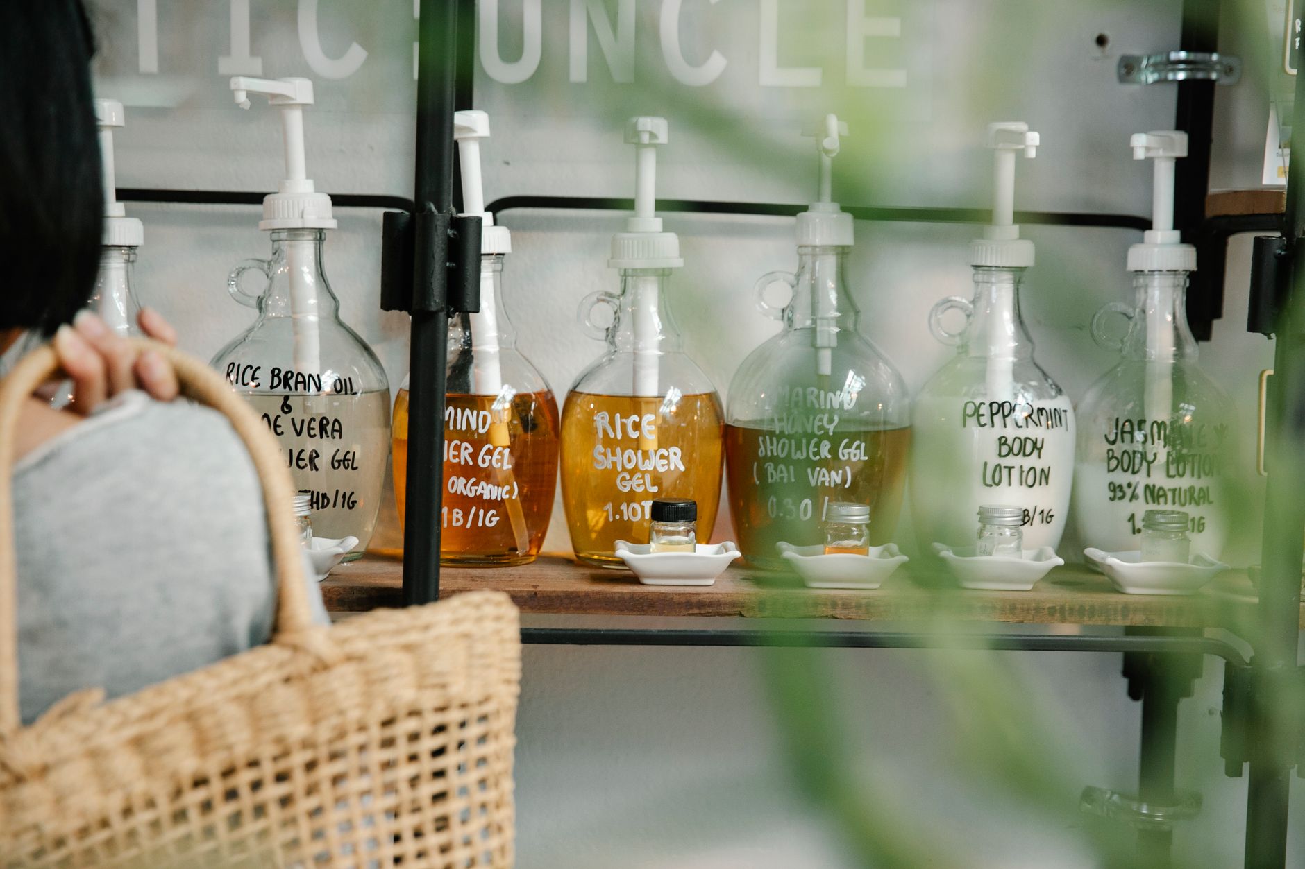 Display of eco friendly personal care products in refillable bottles on a shelf, promoting sustainability.