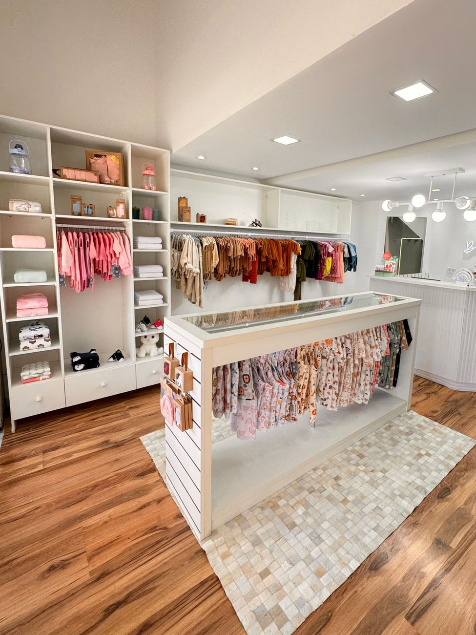 Charming children's boutique with neatly organized clothes, warm lighting, and inviting ambiance.