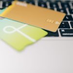 Two credit cards placed on a laptop keyboard highlighting online payment concept.