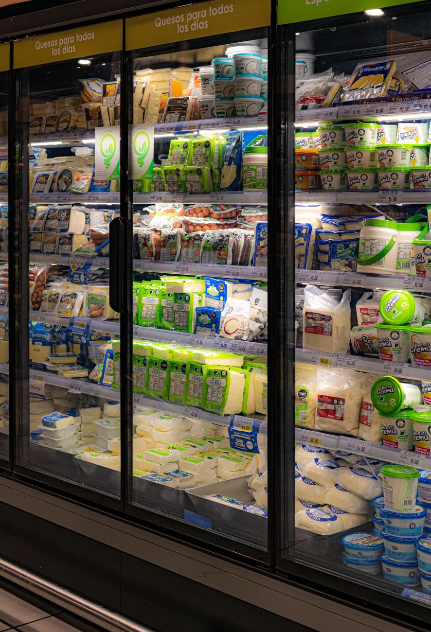 A wide selection of dairy and plant based products in a supermarket refrigerated section.