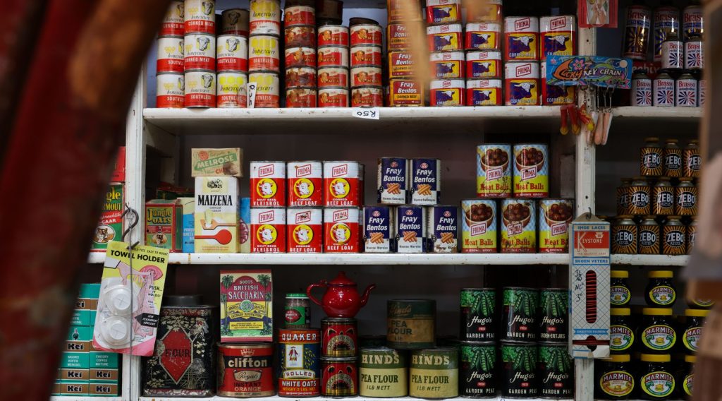 Explore classic canned goods on vintage grocery store shelves, showcasing nostalgic packaging and colors.