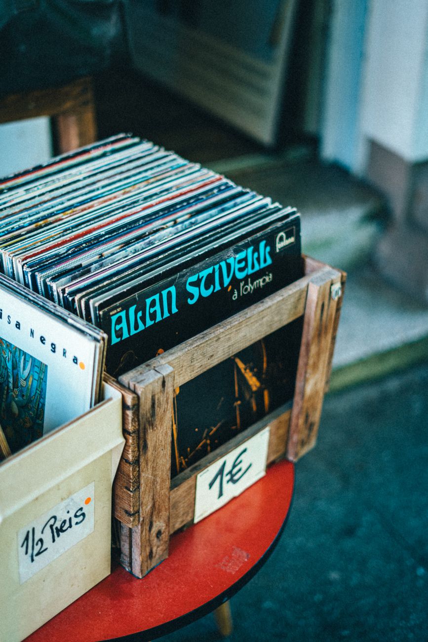A collection of vintage vinyl records displayed in a retail store with price tags.