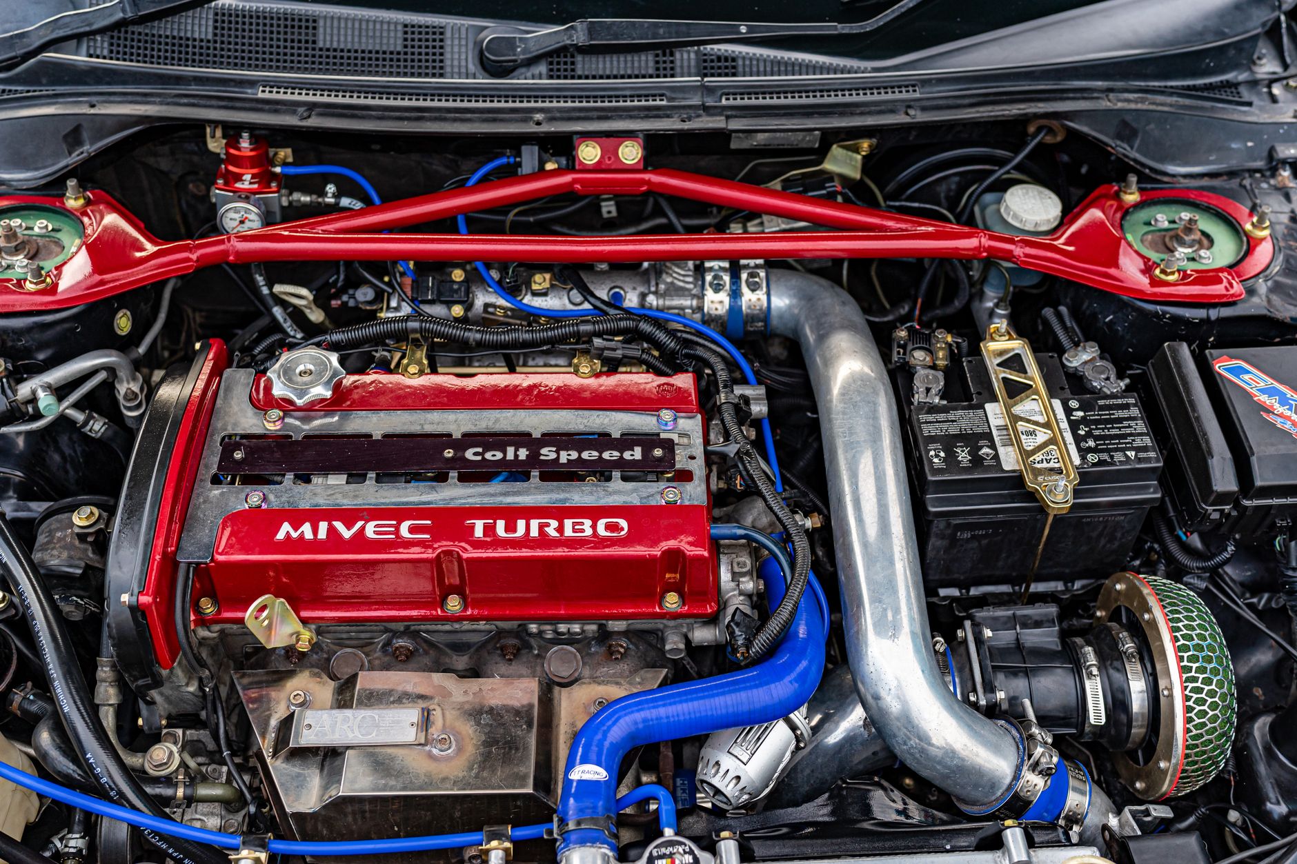 Close up of a high performance MIVEC turbo car engine showcasing technology and engineering.