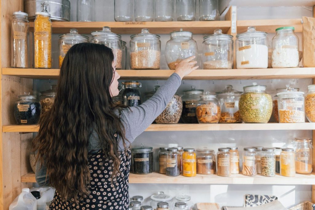 a person holding a jar of food