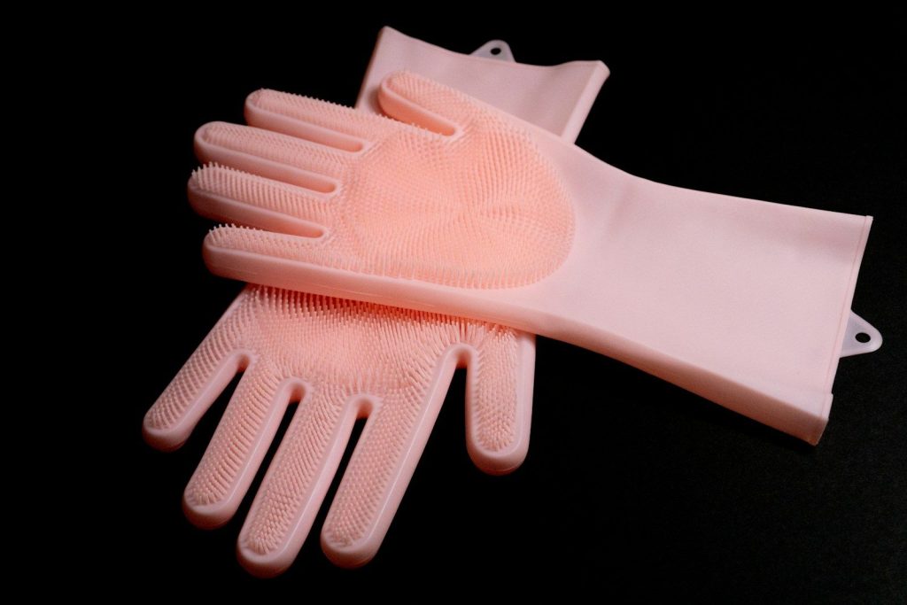 a pair of pink gloves sitting on top of each other