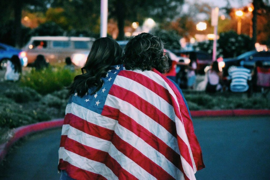woman and man covered USA flag