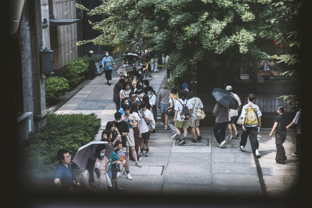 a group of people walking down a street with umbrellas