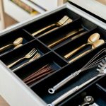 a drawer filled with silverware and wooden spoons
