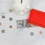 a piggy bank and coins in the snow